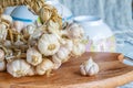 Sliced garlic, garlic clove, garlic bulb in wicker basket place on chopping block on vintage wooden background