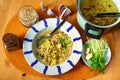 Garlic soup with barley groats and potatoes, pot, garlic, sprouts and groats on table Royalty Free Stock Photo