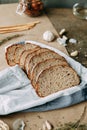 A loaf of white rye bread. Sliced bread on a wooden Board. Slices on a towel Royalty Free Stock Photo