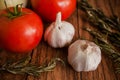 Garlic and tomatoes on a wood background close-up ingredients table top Royalty Free Stock Photo