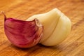 Garlic. Two Purple garlic cloves isolated on a wooden board