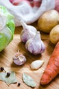 Garlic and vegetables- carrot, cabbage, pepper and laurel leaf Royalty Free Stock Photo