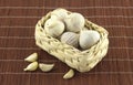 Garlic in wicker basket on straw mat Royalty Free Stock Photo