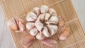 fresh garlic cloves on a bamboo sushi rolling mat Royalty Free Stock Photo
