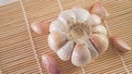 garlic bulb and cloves on bamboo mat close-up Royalty Free Stock Photo