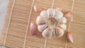 garlic bulb and cloves on a bamboo sushi mat Royalty Free Stock Photo