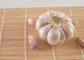 garlic bulb and cloves on bamboo mat close-up Royalty Free Stock Photo