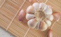 garlic bulb and cloves on bamboo sushi mat Royalty Free Stock Photo