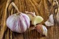 Garlic on Wooden Vintage Background. Garlic Bulb with Garlic Cloves on Chopping Board. Royalty Free Stock Photo