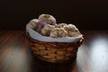 Garlics. Garlic basket, wicker basket with garlic on wooden table. Brown background