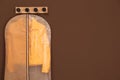 Garment bag with jacket hanging on brown wall. Space for text Royalty Free Stock Photo