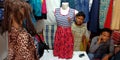 garment shopkeeper showing female fashion outfit into garment showroom in india Nov 2019