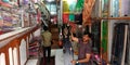 garment showroom incharge presenting women saari at showroom in India