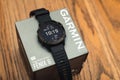 Garmin Fenix 6 Pro smart watch on box on wooden background. Unpacking purchase concept