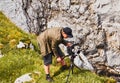 Photographer me professional video camera on a tripod next to a limestone rock at work