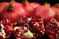 Garnet fruits and pulp on black background. Fresh pomegranate fruits and seeds close up.