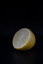 Garnished lemon on dark background, Artistic depiction of lemon half with gloss and pulp details Royalty Free Stock Photo