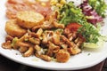 Garnished smoked salmon with motley salad and potato patties, served on plate