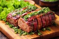 garnishing bacon-wrapped meatloaf with parsley