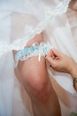 Garter on leg of bride Royalty Free Stock Photo