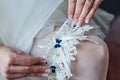 Garter on the leg of a bride, Wedding day moments Royalty Free Stock Photo
