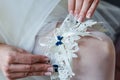 Garter on the leg of a bride, Wedding day moments Royalty Free Stock Photo