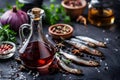 Garum fish sauce in a decanter on the table with fresh sardines and spices.