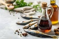 Garum fish sauce in a decanter on the table with fresh sardines and spices.