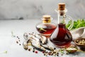 Garum fish sauce in a decanter on the table with fresh sardines and spices.