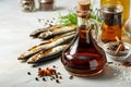 Garum fish sauce in a decanter on the table with fresh sardines and spices.