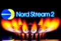 Gas burner on background of Nord Stream 2 logo