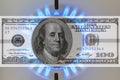 Hundred dollar bill on a gas stove in the center of the gas burner, gas is on, double exposure Gas fuel price growth Royalty Free Stock Photo