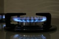 Gas burner of modern stove with burning blue flame, closeup Royalty Free Stock Photo