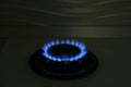 Gas burner of modern stove with burning blue flame at night Royalty Free Stock Photo