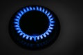 Gas burner of modern stove with burning blue flame at night, closeup Royalty Free Stock Photo