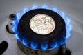 Gas burner and ruble coin, Russian money on home gas stove