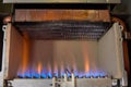 Gas burning in a heating appliance. A stainless steel burner heats a copper heat exchanger Royalty Free Stock Photo