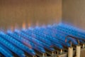 Gas burning in a heating appliance. A stainless steel burner heats a copper heat exchanger Royalty Free Stock Photo