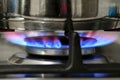 Gas cooking. The blue flames of the gas heat the food in the container Royalty Free Stock Photo