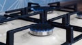 Gas cooktop with burning blue flames in kitchen, closeup. Cooking appliance Royalty Free Stock Photo