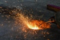 A gas cutter in production, a welder removes unnecessary metal residues with a gas cutter, sparks fly in different directions