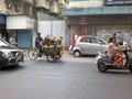 Gas cylinder delivery using tricycle in the streets of Mumbai, India