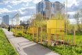 Gas distribution complex for supplying homes and businesses with valves and shut-off equipment in closed yellow boxes and pipes Royalty Free Stock Photo