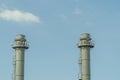 Gas flares in petroleum refinery  with blue sky background Royalty Free Stock Photo