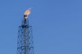 Gas flares in petroleum refinery with blue sky background Royalty Free Stock Photo