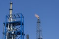 Gas flares in petroleum refinery with blue sky background Royalty Free Stock Photo