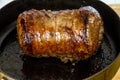 Browning a beef brisket joint , in a frying pan