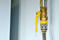 Gas Isolating Valve on pipe in house. The yellow handle lever ball valve is a full-bore brass ball valve, suitable for use with