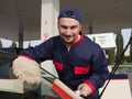 Gas Jockey Cleaning Windshield Royalty Free Stock Photo