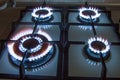 Gas kitchen stove with burning blue flame in dark Royalty Free Stock Photo